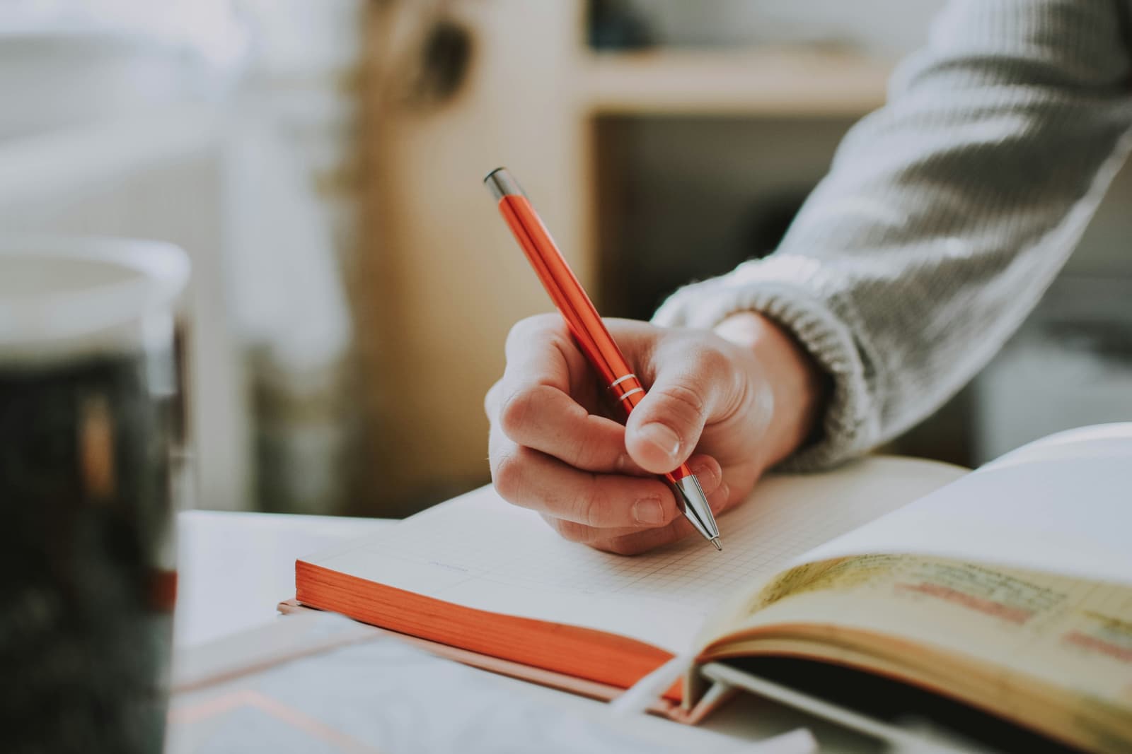 Handwritten notes beside a notebook as a UK training provider compares essential digital skills qualification specifications