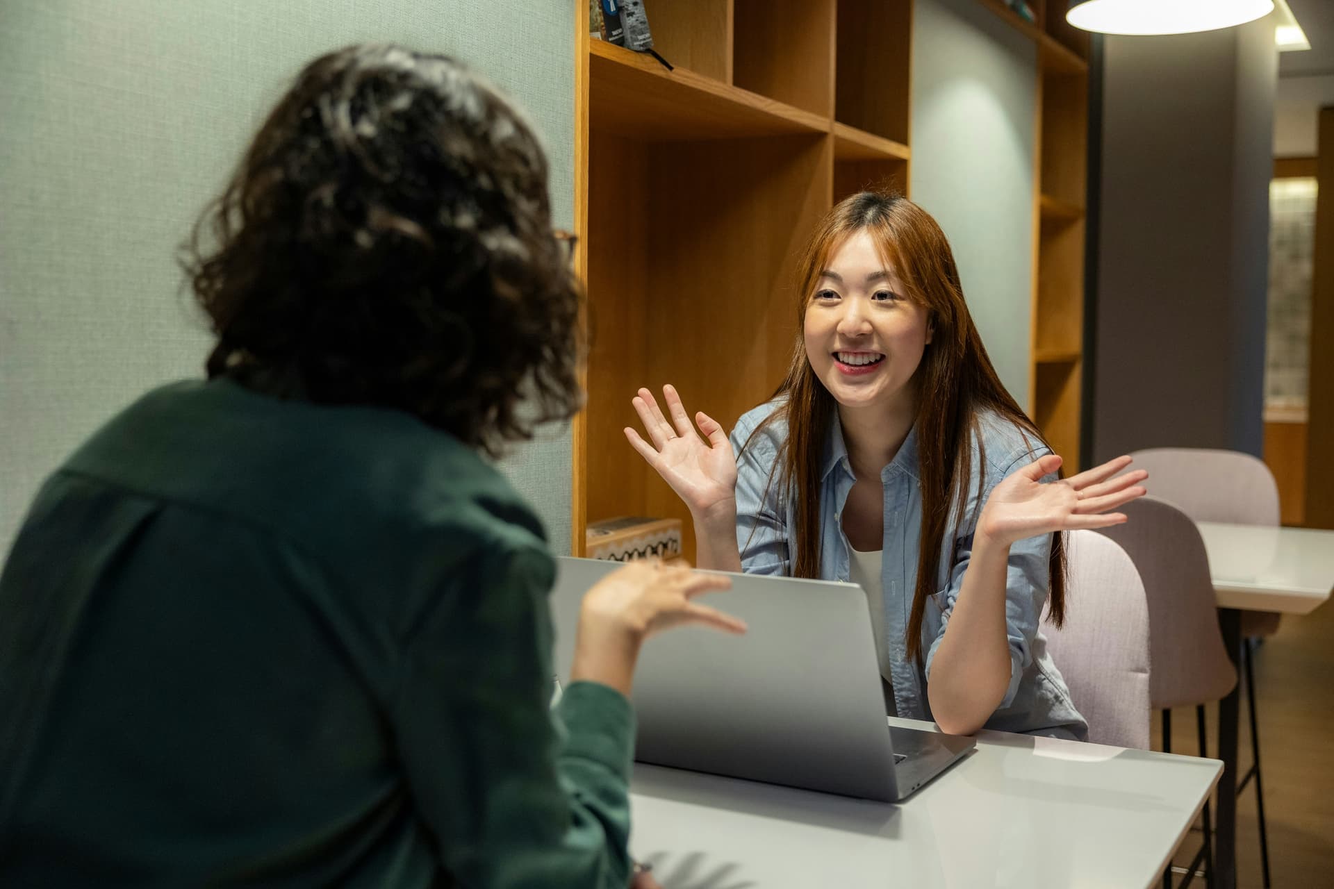 A training provider discussing digital skills assessment with a learner across a desk